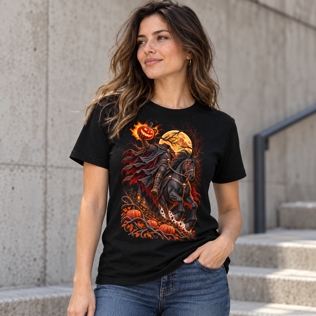 Female model wearing Astral Drift’s Headless Horseman black graphic T-shirt with fiery pumpkin and charging horse artwork.